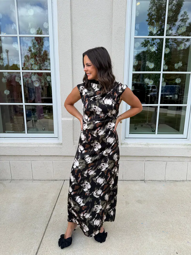 Woman wearing a black and olive satin dress