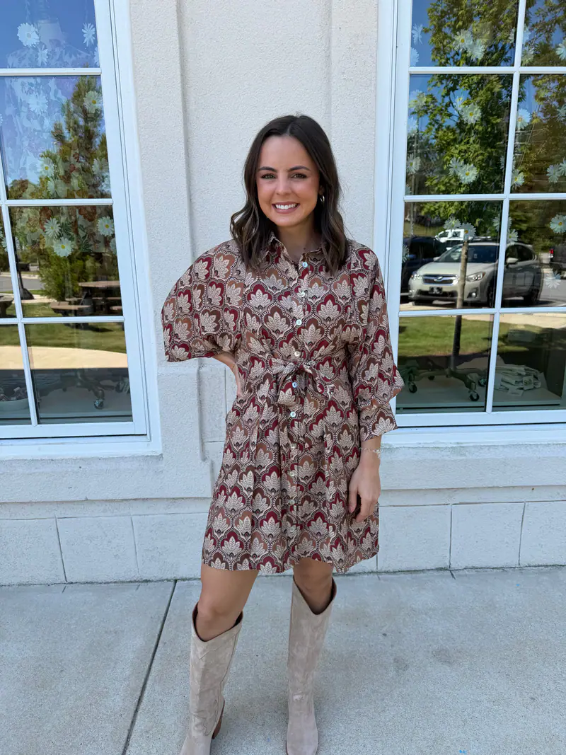 Madison wearing a brown and burgundy front tie mini dress
